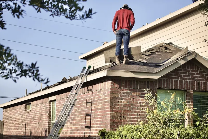 Professional roofer working on a residential roof in Parrish
